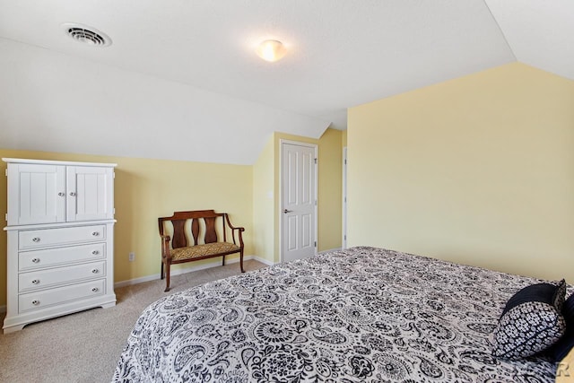 bedroom featuring light colored carpet and lofted ceiling