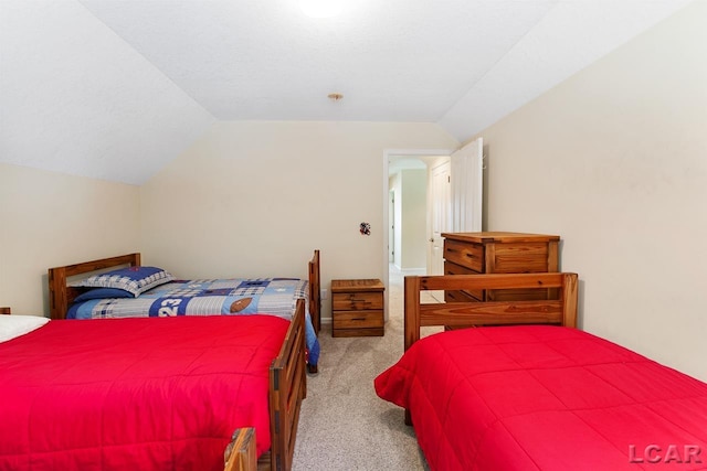 carpeted bedroom featuring lofted ceiling