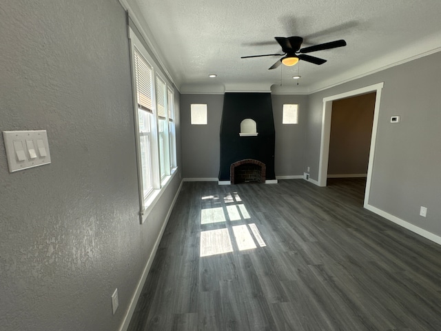 unfurnished living room featuring ceiling fan, plenty of natural light, dark wood-type flooring, and ornamental molding