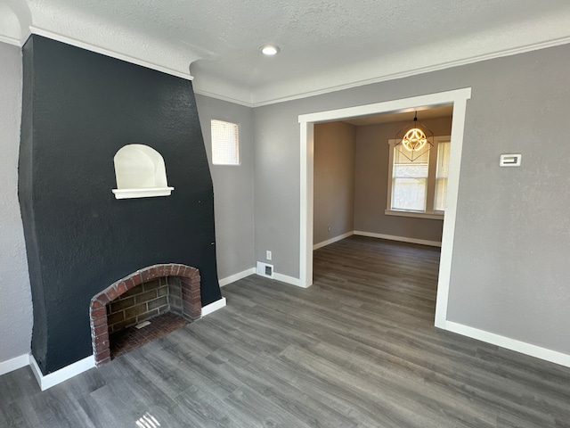 living room with a textured ceiling, hardwood / wood-style flooring, and ornamental molding