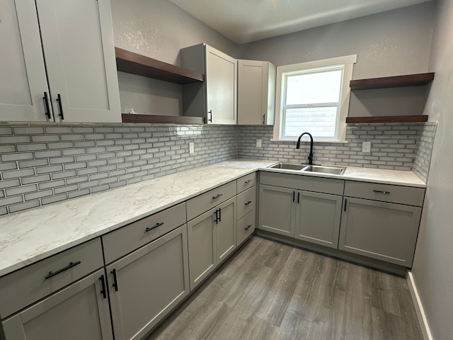 kitchen with dark hardwood / wood-style flooring, gray cabinets, and sink