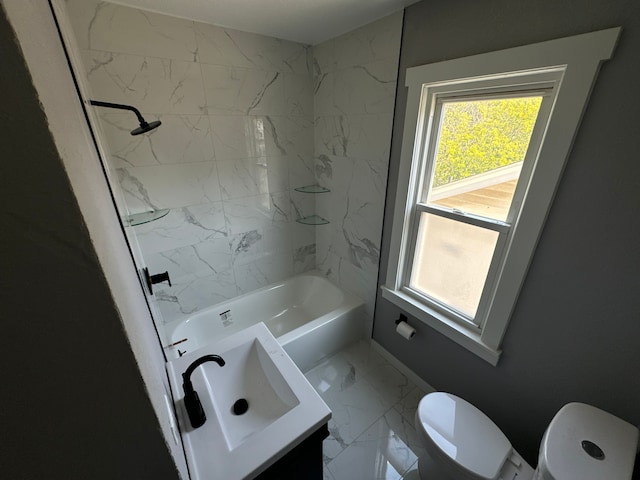 full bathroom with vanity, tiled shower / bath combo, and toilet