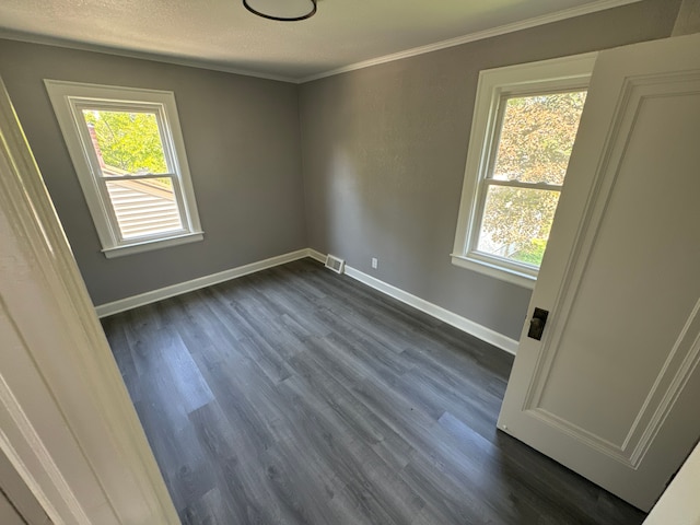 spare room with dark hardwood / wood-style floors and ornamental molding