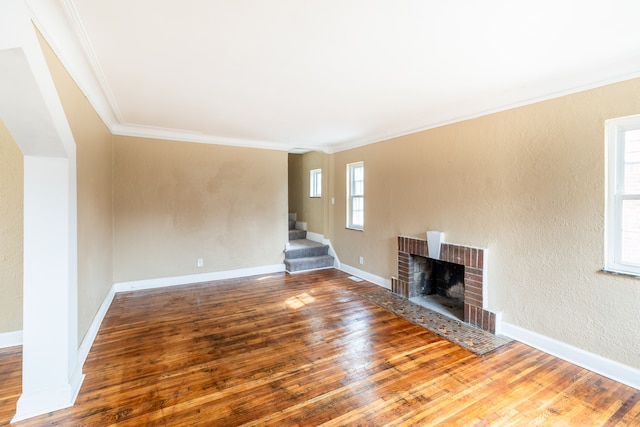 16184 Manor St, Detroit, MI 48221 - unfurnished living room featuring hardwood / wood-style flooring, a fireplace, stairway, ornamental molding, and baseboards