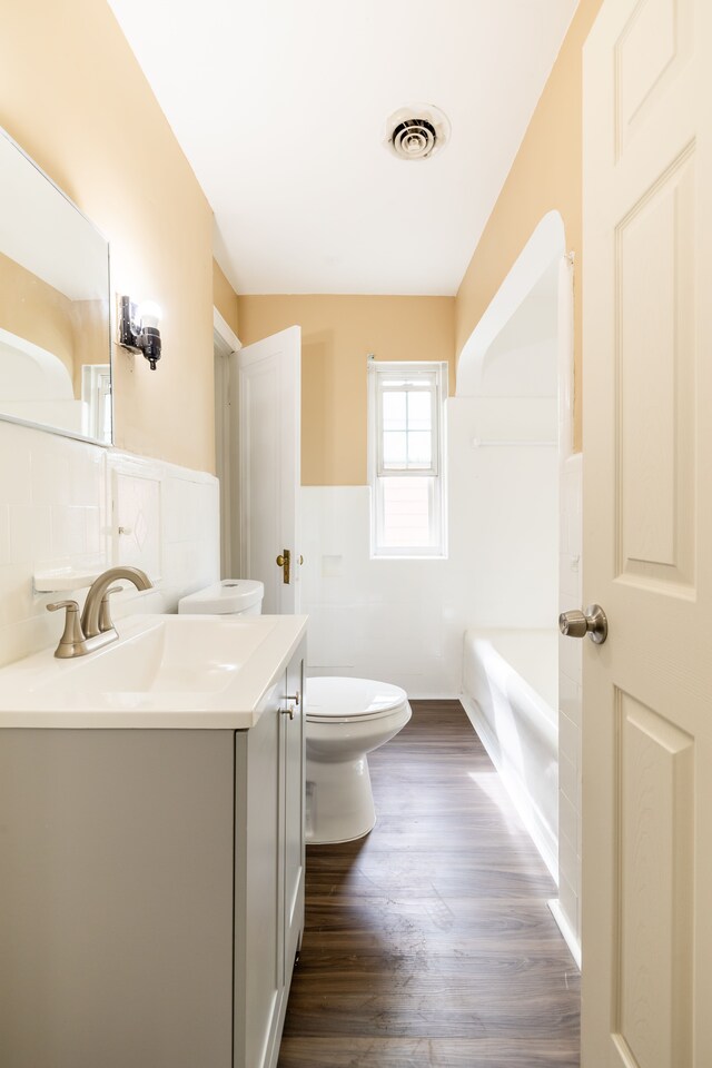 16184 Manor St, Detroit, MI 48221 - full bathroom with toilet, wood finished floors, vanity, and a tub to relax in
