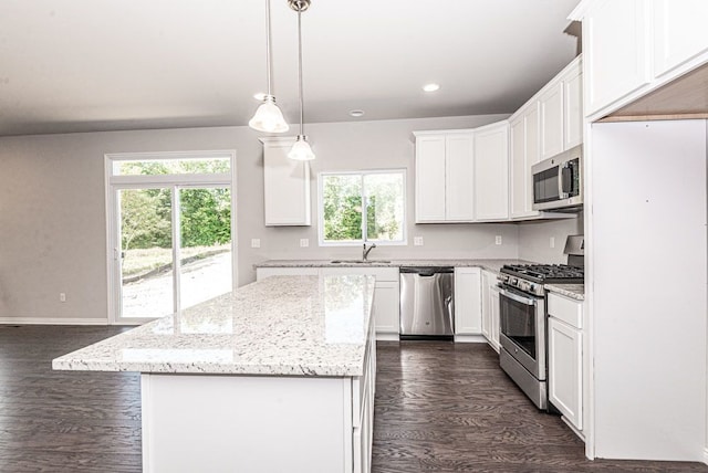 53207 Woodland Mdws, Chesterfield, MI 48047 - kitchen featuring stainless steel appliances, dark wood-type flooring, a kitchen island, white cabinetry, and light stone countertops