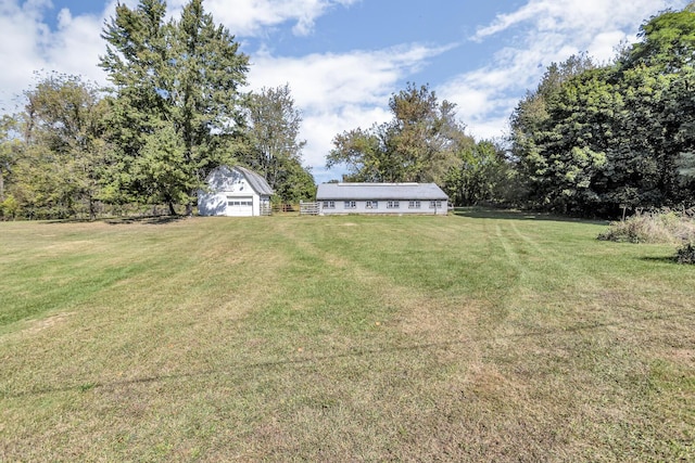10526 Spring Arbor Rd, Spring Arbor, MI 49283 - view of green lawn featuring a detached garage and an outbuilding
