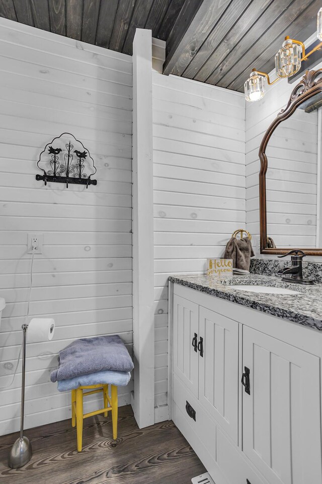 10526 Spring Arbor Rd, Spring Arbor, MI 49283 - bathroom with wood finished floors, vanity, wooden ceiling, and wood walls