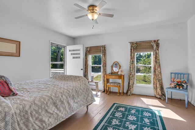 10526 Spring Arbor Rd, Spring Arbor, MI 49283 - bedroom featuring multiple windows, wood-type flooring, and a ceiling fan
