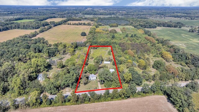 10526 Spring Arbor Rd, Spring Arbor, MI 49283 - aerial view of property and surrounding area featuring property boundaries highlighted and a heavily wooded area