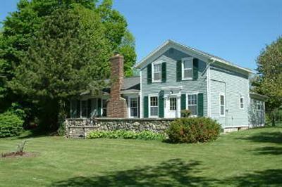5295 Belding Rd NE, Rockford, MI 49341 - back of property with a chimney and a lawn