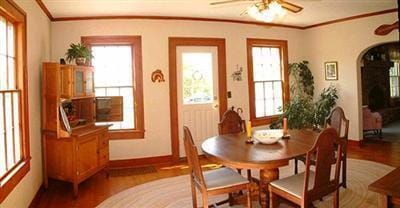 5295 Belding Rd NE, Rockford, MI 49341 - dining room featuring ceiling fan, wood finished floors, crown molding, arched walkways, and baseboards