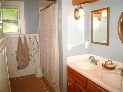 bathroom featuring curtained shower and vanity