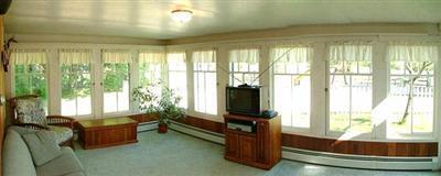 sunroom featuring a baseboard heating unit