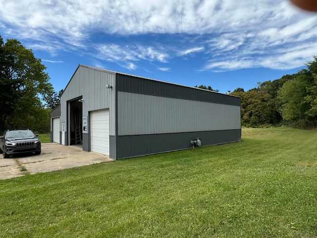 view of outdoor structure with a lawn and a garage