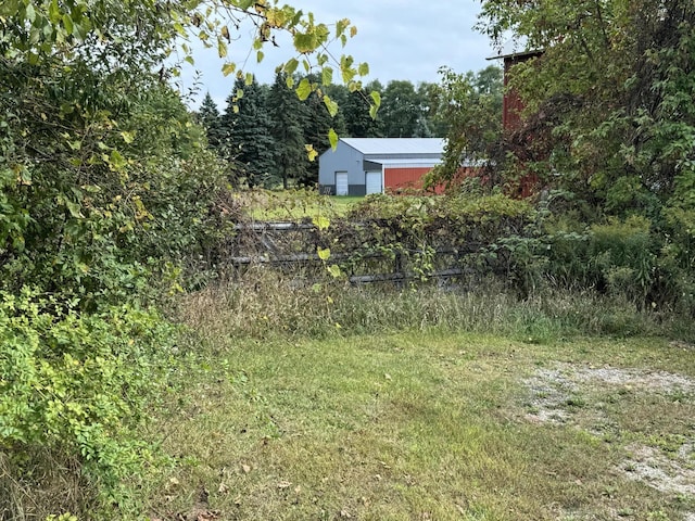 5295 Belding Rd NE, Rockford, MI 49341 - view of yard with an outbuilding, a forest view, and a pole building