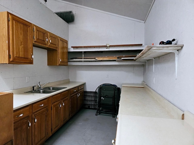 kitchen featuring vaulted ceiling and sink