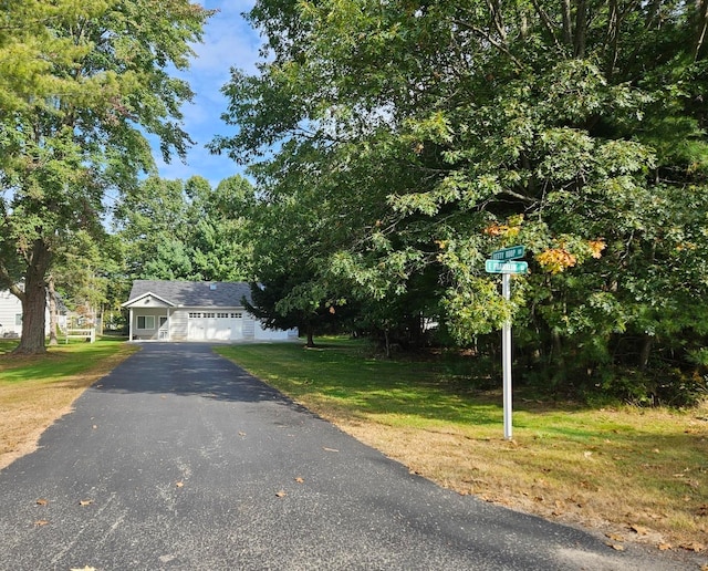 view of front of property with a front yard and a garage