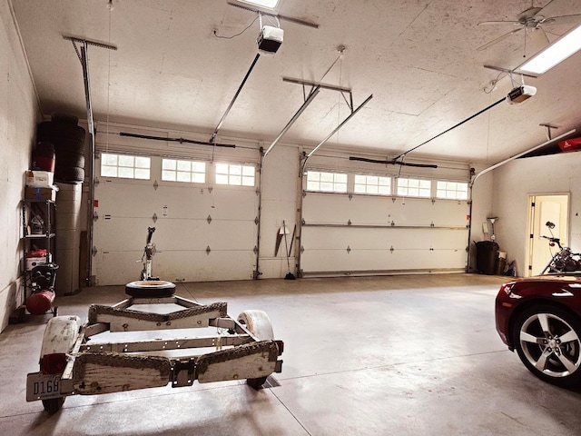 garage with a garage door opener and ceiling fan