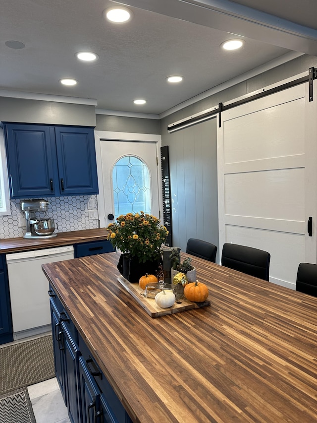 kitchen with dishwasher, backsplash, blue cabinets, a barn door, and butcher block counters