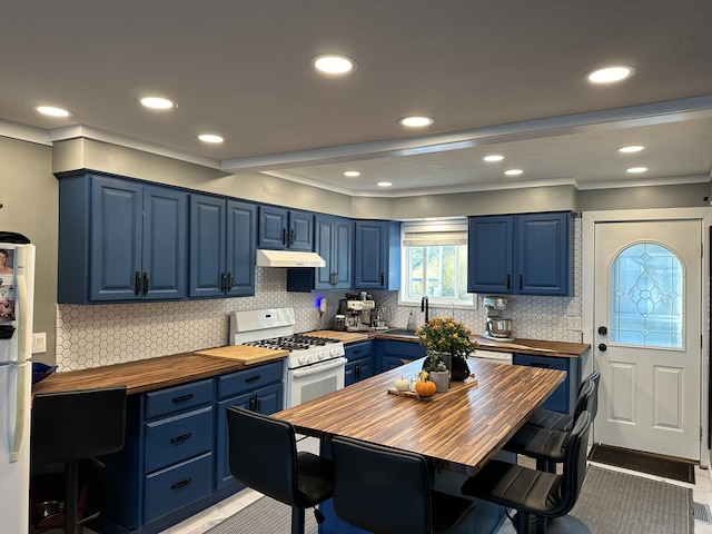 kitchen featuring butcher block countertops, blue cabinets, backsplash, and gas range gas stove