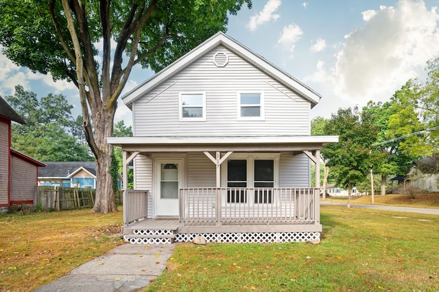 view of front of house with a porch and a front lawn