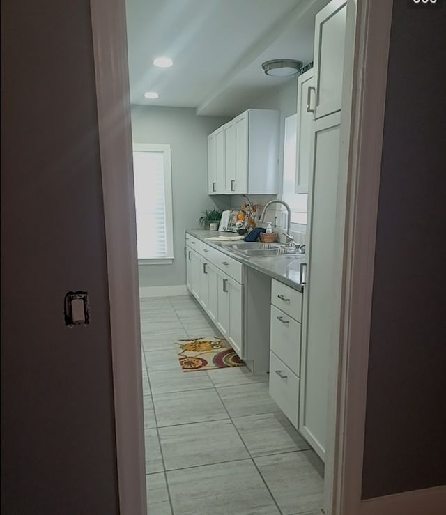 4134 Devonshire Rd, Detroit, MI 48224 - kitchen featuring white cabinetry, sink, and light tile patterned floors