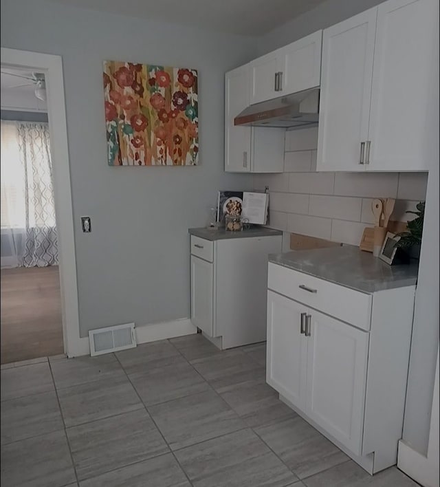 4134 Devonshire Rd, Detroit, MI 48224 - kitchen featuring decorative backsplash and white cabinets