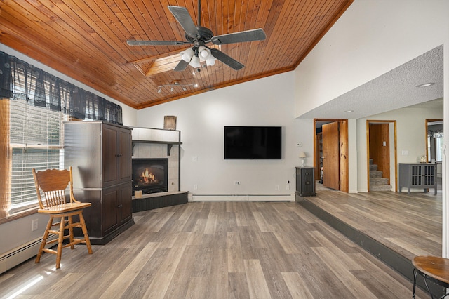 living room with ornamental molding, wood ceiling, and light wood-type flooring