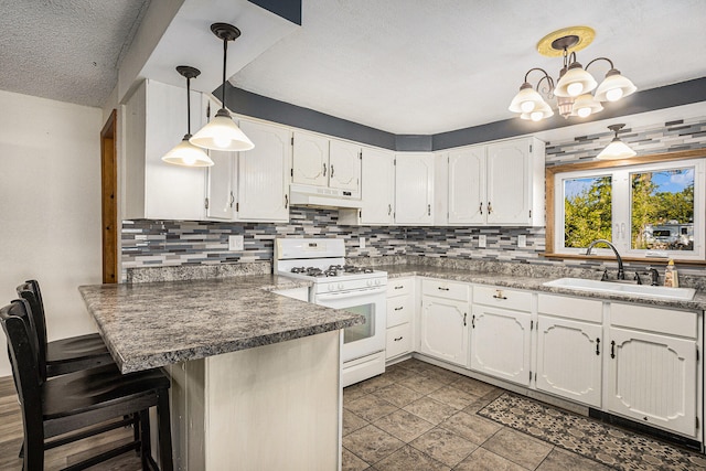 kitchen with sink, kitchen peninsula, decorative light fixtures, white range with gas cooktop, and white cabinets