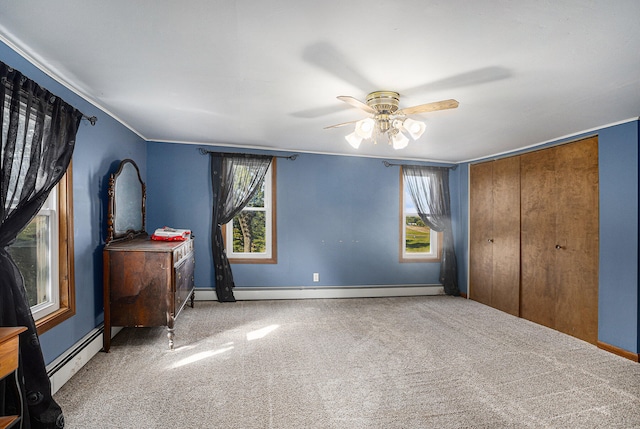 unfurnished bedroom featuring ceiling fan, a closet, carpet floors, and a baseboard heating unit