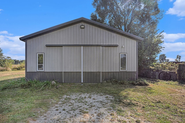 view of side of home featuring an outbuilding