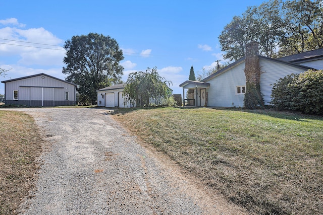 exterior space featuring an outbuilding, a garage, and a front lawn