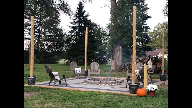 view of yard featuring a fire pit and a patio area