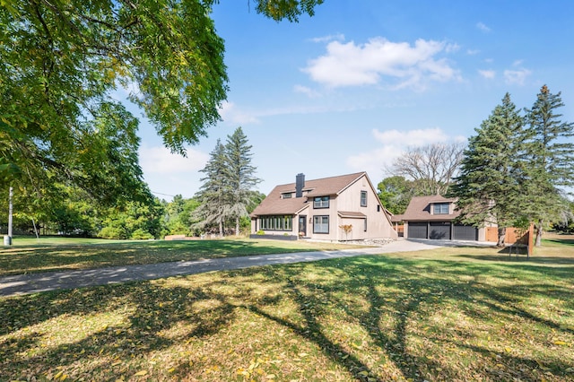 20616 Madison Ave, Big Rapids, MI 49307 - view of front of property with a chimney, a garage, and a front yard