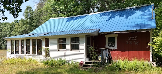 3376 Swihart Rd, Brethren, MI 49619 - view of front of house with metal roof and a sunroom