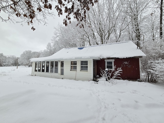 view of snow covered back of property