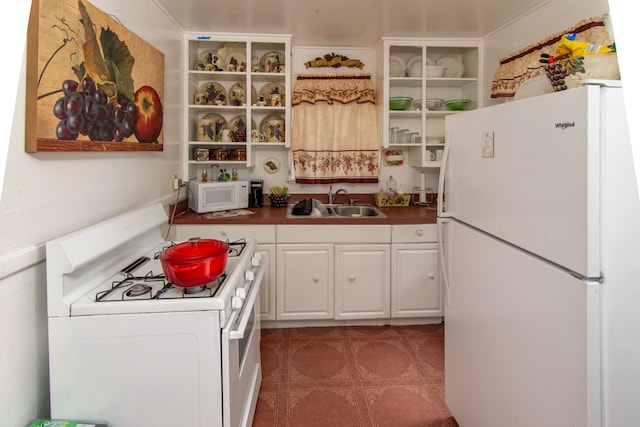 kitchen with sink, white cabinets, and white appliances