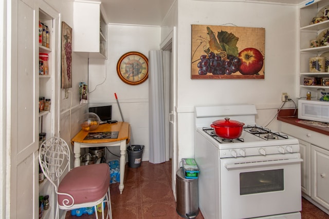 kitchen featuring white cabinetry and white appliances