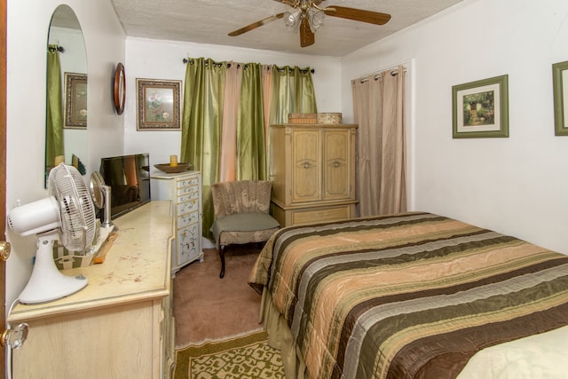 bedroom with ceiling fan, light carpet, and a textured ceiling