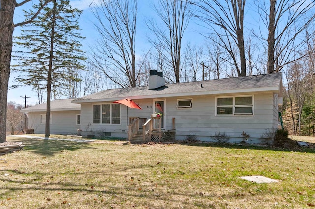 back of house with a lawn