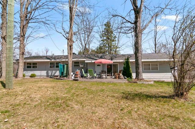 rear view of house with a yard and a patio area