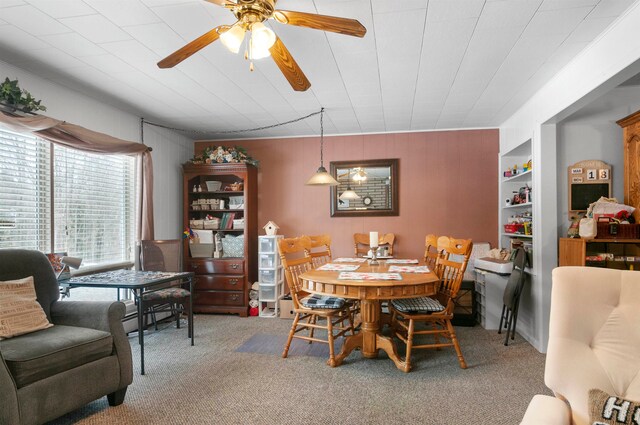 dining area featuring carpet, ceiling fan, and built in features