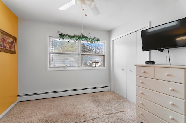 interior space featuring baseboard heating, light carpet, and ceiling fan