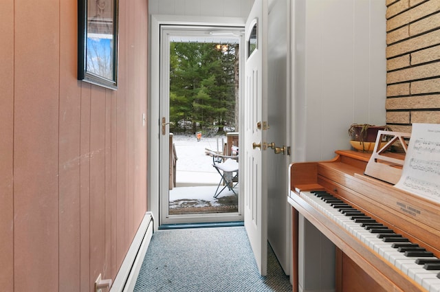 entryway featuring a baseboard heating unit and wood walls