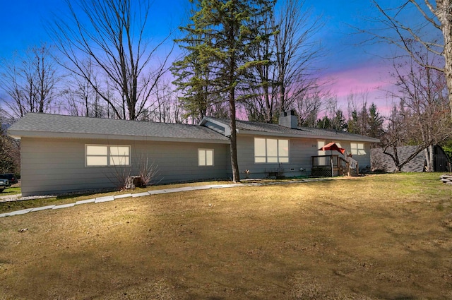 back house at dusk with a yard