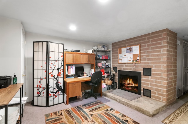 carpeted office with a fireplace