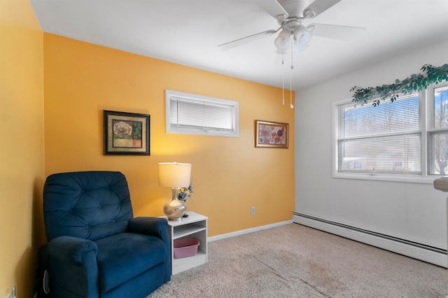 living area featuring ceiling fan, light colored carpet, and a baseboard radiator