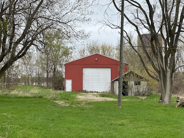 view of outdoor structure featuring a yard and a garage