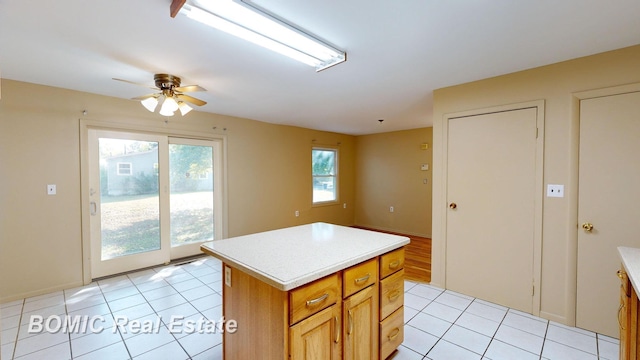 kitchen featuring plenty of natural light, a kitchen island, and light tile patterned floors